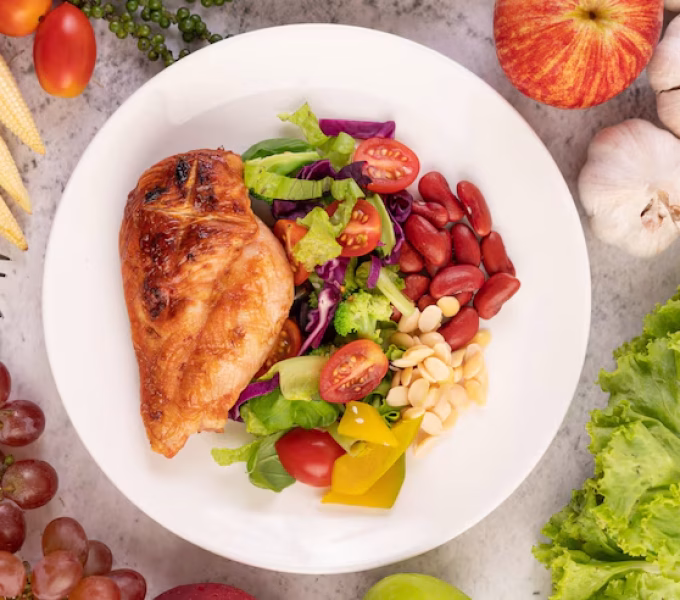 chicken-steak-topped-with-white-sesame-peas-tomatoes-broccoli-pumpkin-white-plate_1150-24770