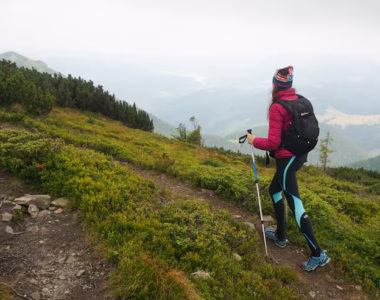 wide-shot-woman-walking-up-mountain-with-complete-gear-cold-foggy-weather_181624-20880